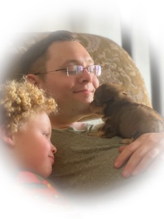 a man, a kid, and a puppy